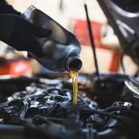Oil being poured into car